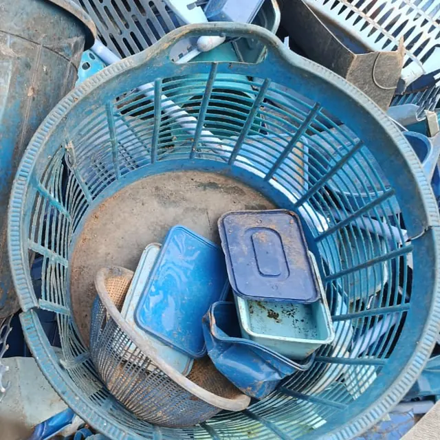 Pile of sorted blue plastic baskets, bins and containers